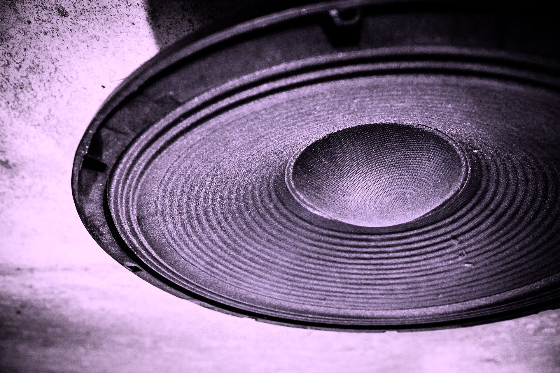 Why do speaker drivers use different materials?