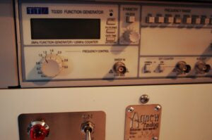 A Thurlby Thandar function generator and an Agnew Analog current-regulated power supply unit on one of the equipment racks.