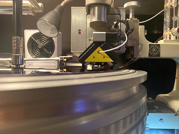 Greg’s Neumann SX74 stereophonic cutter head, on the Neumann VMS-70 lathe. The little tube at the front delivers helium to the cutter head, to assist with cooling the drive coils, which operate in a helium atmosphere. (Helium has a higher thermal conductivity than atmospheric air!)