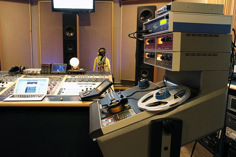 The Ampex ATR-104 from the side, with the mastering console visible in the background.