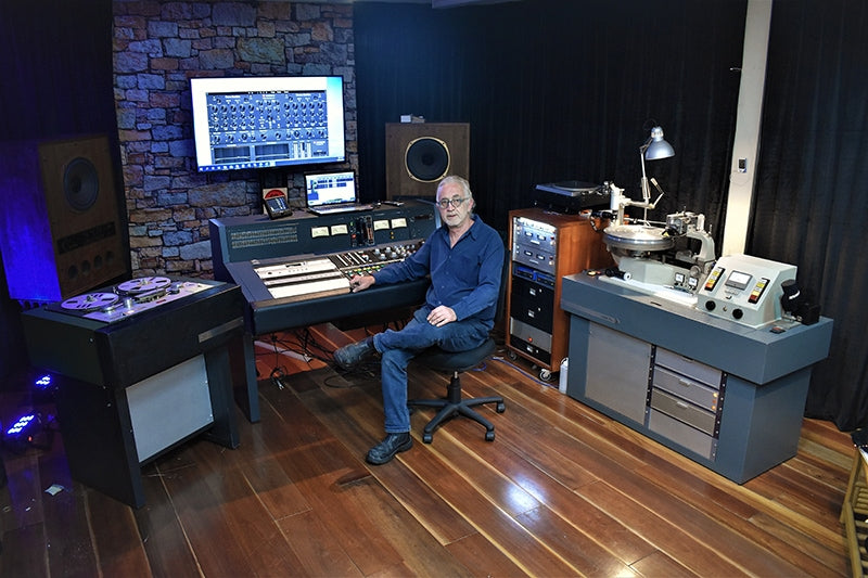 Mike Papas in his Mastering Studio with a Neumann VMS-70 lathe, transfer console and preview head tape machine.