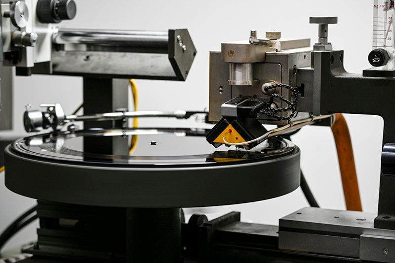 The Neumann SX-74 stereophonic feedback cutter head, along with the matching suspension box, mounted on a modified Neumann VMS-82 lathe. At the opposite end of the vacuum platter, there is an SME 3012 playback tonearm, for calibration of the system and for checking cuts on the spot. Photo courtesy of Scott Hull, owner/chief engineer, Masterdisk Studios, Peekskill, NY.