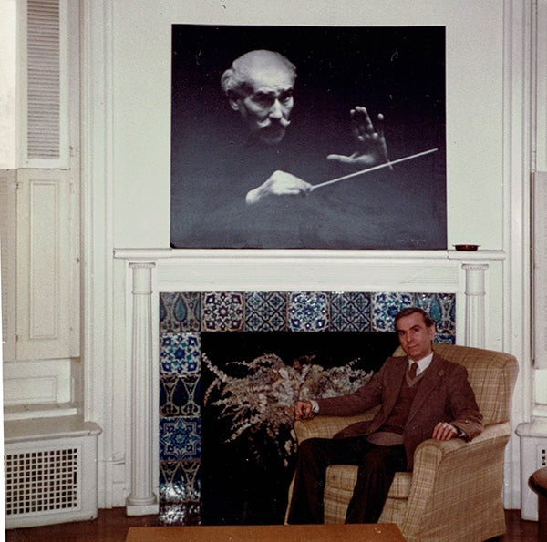 Mel Schilling relaxing under a photo of Arturo Toscanini.