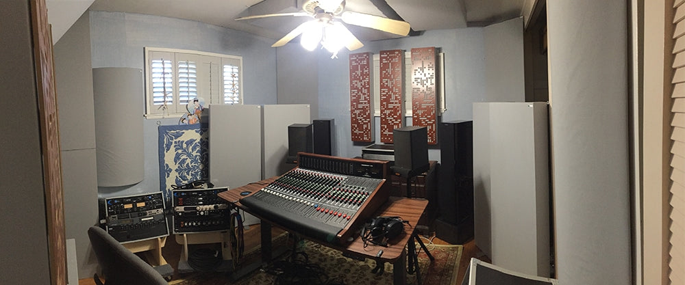 The mixing studio with GIK acoustic treatment and the effects rack (left), and the recording rack in place (lower right corner). The mixing console is a Trident-78-16. The monitor speakers are Boston Acoustics CR7 and Dynaudio Focus 340, powered by a pair of modified Carver M1.5t amps. REL Stratus III subwoofers are hidden behind the panels. 