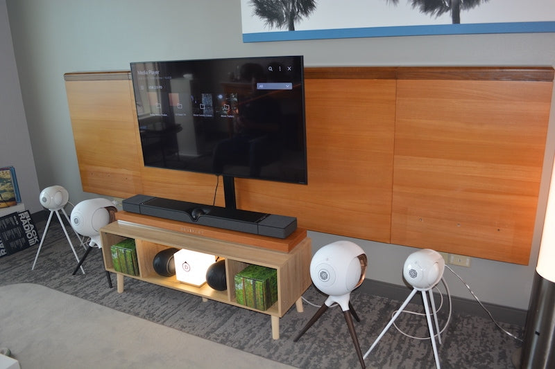 Devialet Dione soundbar (under the TV) and other Devialet speakers.