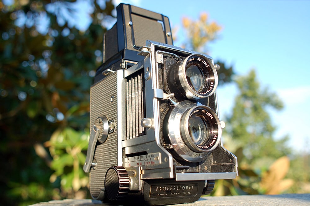 Above images: Mamiya C3 Professional twin-lens reflex (TLR) camera with waist-level viewfinder, for medium-format film (120) in 6x6 frame size. It was manufactured in Japan in the 1960s. It's fitted with a Mamiya-Sekor 80 mm lens assembly with a leaf shutter built into the lens. Courtesy of Agnew Analog Reference Instruments.