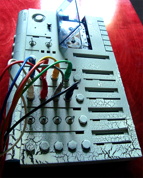 Originally a Tascam 414 MK II cassette tape 4-track recorder with a built-in mixing board that served as the author's first multi-track recording device, it was soon discovered that the weakest point was the built-in mixing board electronics. J.I. Agnew gutted it out and replaced it with inputs and outputs for connecting an external mixing console of much higher performance and capabilities. Countless recordings on cassette tape and a variety of odd jobs later, the author was finally able to afford professional recording equipment and the rest, as they say, is history. Courtesy of the author's archive of audio adventures.