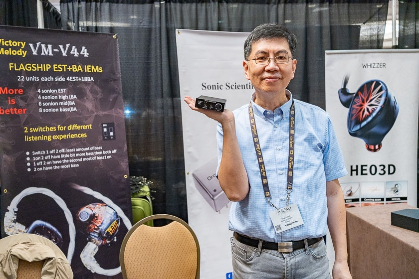 Sean Hsieh of Sonic Scientific, in T.H.E. Marketplace, holding his newly-released headphone amplifier.