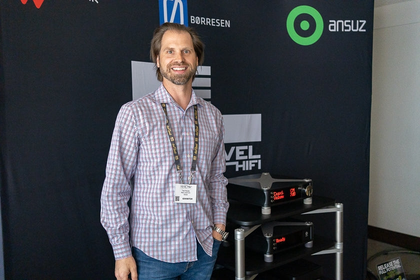 Tyler Mueller, owner of Next Level Hi-Fi, and a stack of Aavik electronics.