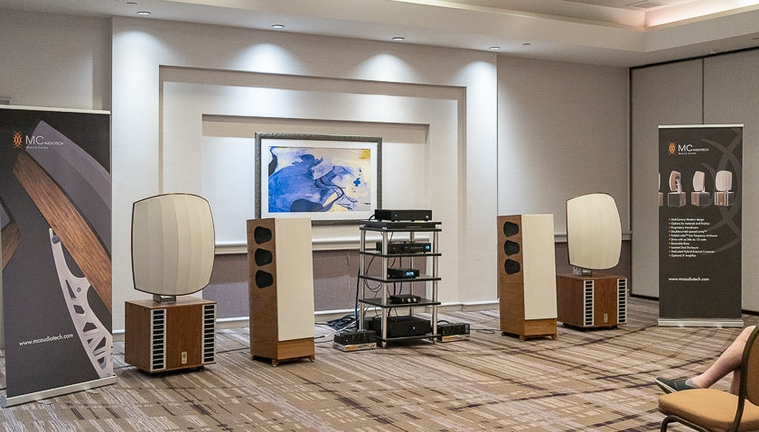 The MC Audiotech room featured their unique and well-regarded Forty-10 speakers, featuring the company's double-curved spaces array and folded cube bass enclosure. The smaller TL-12 speakers are poised next to them. Other components included a Wolf Audio Systems server, Weiss DAC 501, Linear Tube Audio MicroZOTL preamp, EAR 509 amplifiers, and Audience frontRow cables.